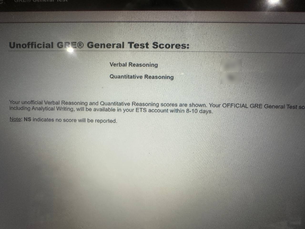 The same unofficial GRE score report, up close. Both section scores are blurred; the total landed comfortably above her target.